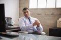 Mixed race businessman at an office desk looking to camera Royalty Free Stock Photo