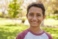 Mixed race Caucasian Asian boy in park looking to camera