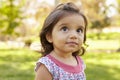 Mixed race Caucasian Asian toddler girl in a park, portrait