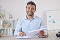 Mixed race cheerful Businessman executive writing notes on paper . Male Hispanic financial advisor smiling and sitting Royalty Free Stock Photo