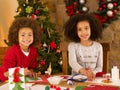 Mixed race children making Christmas cards