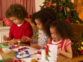 Mixed race children making Christmas cards