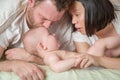 Mixed Race Chinese and Caucasian Baby Boy Laying In Bed with His