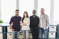 Mixed race confident business team stands in office