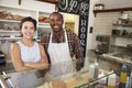 Mixed race couple behind the counter at a sandwich bar Royalty Free Stock Photo