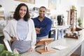 Mixed race couple behind the counter at their coffee shop Royalty Free Stock Photo