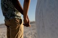 Mixed race couple holding hands and smiling into the camera on a sunny day Royalty Free Stock Photo