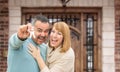 Mixed Race Couple In Front of Front Door of New House Holding Keys Royalty Free Stock Photo