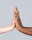 Mixed race couple holding hands. High-five gesture and tenderness of friendship between Black, white Woman and man