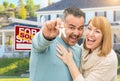 Mixed Race Couple With Keys in Front of Real Estate Sign and New Royalty Free Stock Photo