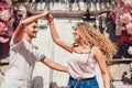 Mixed race couple in love dancing on city street. Young people having fun outdoors