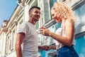 Mixed race couple in love listening to the music on phone and dancing on city street using earphones Royalty Free Stock Photo