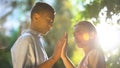 Mixed-race couple in love putting hands together in park, trustful relations