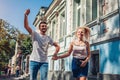 Mixed race couple in love walking and talking on city street. Happy couple hanging and having fun outdoors Royalty Free Stock Photo