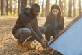 Mixed race couple making tent together, having conversation Royalty Free Stock Photo