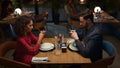 Couple ordering food online at fancy restaurant table on romantic evening date. Royalty Free Stock Photo