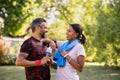 Mixed race couple taking a break after jog at park Royalty Free Stock Photo