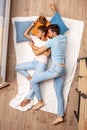 Mixed Race Couple. Young man and woman lying on bed top view hugging sleeping peaceful Royalty Free Stock Photo