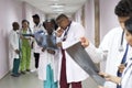 mixed race doctors. Young people of different sexes in the corridor of the hospital look at X-rays, discuss health problems