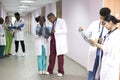 Mixed race doctors. Young people of different sexes in the corridor of the hospital look at X-rays, discuss health problems