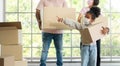 Mixed Race families are carrying cardboard boxes and walking from the front door into the house in a new house on moving day. Royalty Free Stock Photo