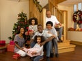 Mixed race family with Christmas tree and gifts Royalty Free Stock Photo