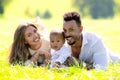 Mixed race family outdoor portrait. Parents and child family portrait in park. Happy African American dad and mixed race Royalty Free Stock Photo