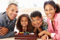 Mixed race family playing solitaire