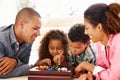 Mixed race family playing solitaire Royalty Free Stock Photo