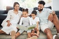 Mixed race family reading a book together on the floor at home. Hispanic mother and father teaching their little son and Royalty Free Stock Photo