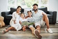 Mixed race family reading a book together on the floor at home. Hispanic mother and father teaching their little son and Royalty Free Stock Photo