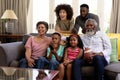 Mixed race family spending time together watching game Royalty Free Stock Photo