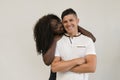 Mixed race family. Young tender wife hugging his husband. Loving