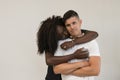 Mixed race family. Young tender wife hugging his husband. Loving Royalty Free Stock Photo