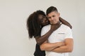 Mixed race family. Young tender wife hugging his husband. Loving