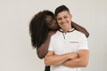 Mixed race family. Young tender wife hugging his husband. Loving