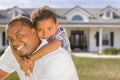 Mixed Race Father and Son In Front of House Royalty Free Stock Photo