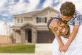 Mixed Race Father and Son In Front of House