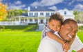 Mixed Race Father and Son In Front of House Royalty Free Stock Photo