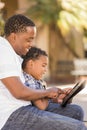 Mixed Race Father and Son Using Touch Pad Computer Royalty Free Stock Photo