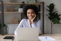 Mixed race female employee posing at work desk by laptop Royalty Free Stock Photo