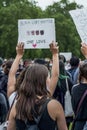 UK, London, 3/6/2020 - A mixed race female holding a Black Lives Matter One Love banner at an anti racism protest in London