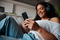 Mixed race female teen texting on cellular device relaxing at home Royalty Free Stock Photo