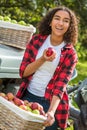 Mixed Race Female Teenager Leaning on Tractor Eating Apple Royalty Free Stock Photo