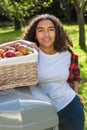 Mixed Race Female Teenager Leaning on Tractor Picking Apples Royalty Free Stock Photo