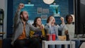 Mixed race friends relaxing on couch while watching football game Royalty Free Stock Photo