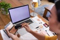 Mixed race gender fluid man using makeup making vlog with laptop, copy space screen Royalty Free Stock Photo