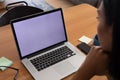 Mixed race gender fluid man working at home making video call using laptop, copy space screen Royalty Free Stock Photo