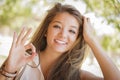 Mixed Race Girl Portrait with Okay Hand Sign Outdo