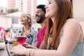 Mixed race group bonding and drinking at cafe bar outdoor. Spring, warm, togetherness, lifestyle, diversity concept. Royalty Free Stock Photo